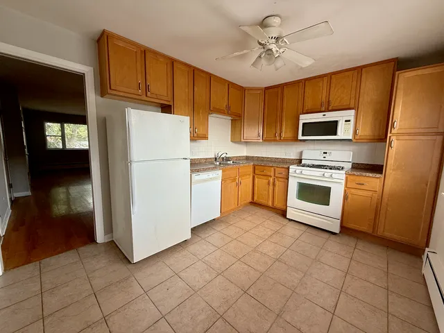 a kitchen with cabinets stainless steel appliances and a counter top space