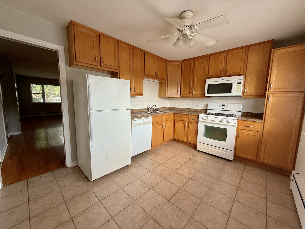317 South Plum Grove Road, Unit 5 Palatine, IL 60067 - Photo 6 of 14 a kitchen with cabinets stainless steel appliances and a counter top space