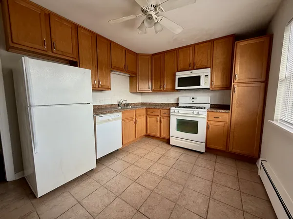 a kitchen with cabinets stainless steel appliances and a counter space