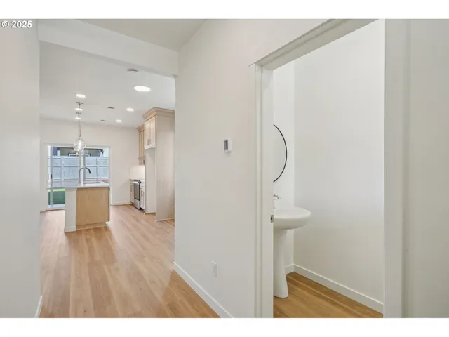 a view of a room with wooden floor and a bathroom