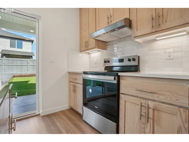 a kitchen with kitchen island granite countertop a stove and a sink