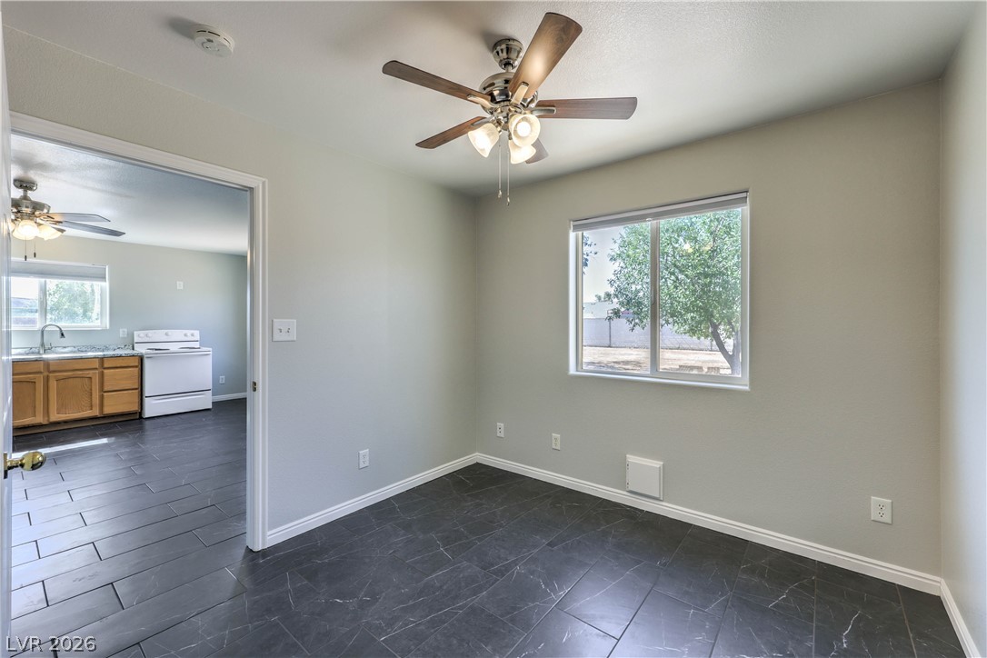 348 Tres Palomas Street Overton, NV 89040 - Photo 32 of 41 A versatile space offers rich dark tile flooring and a view of verdant trees from the window.
