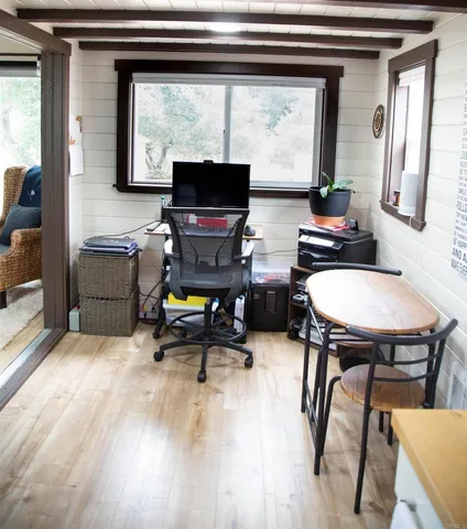 a view of a workspace with furniture and a window