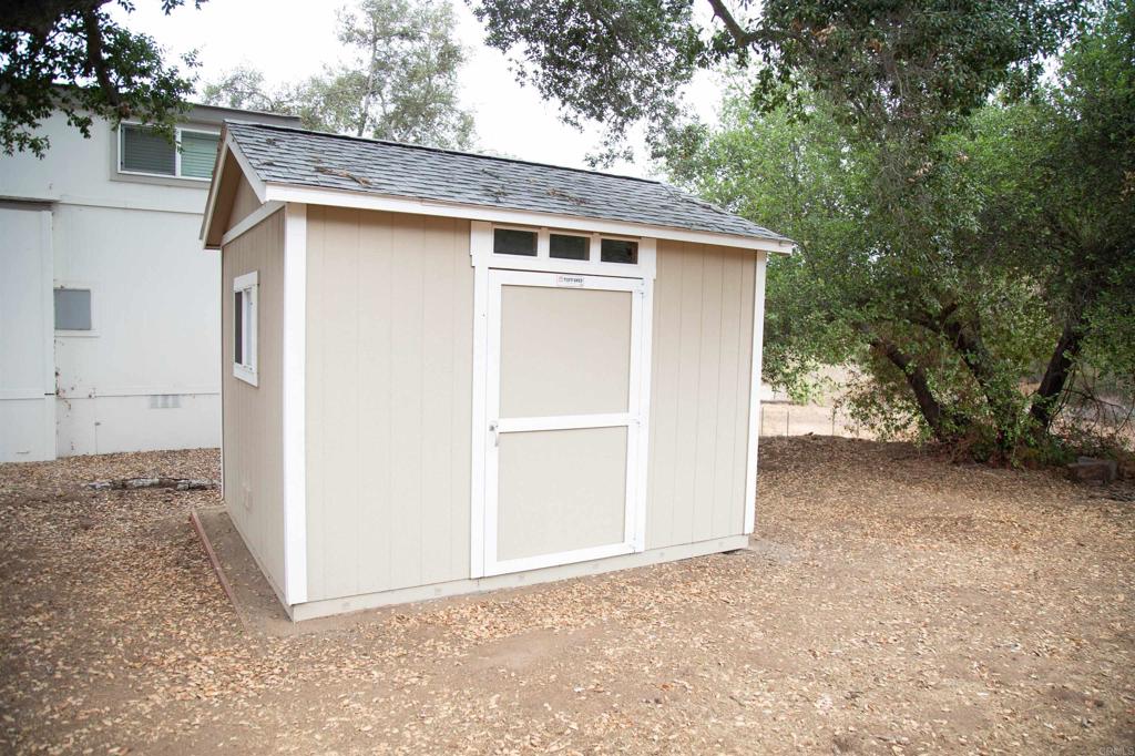 14625 Mussey Grade Road, Unit R67 Ramona, CA 92065 - Photo 17 of 31 a view of a house with a backyard