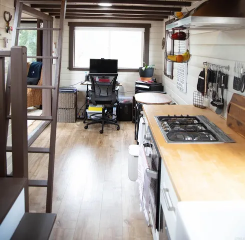 a kitchen with stainless steel appliances granite countertop a stove and a wooden floors