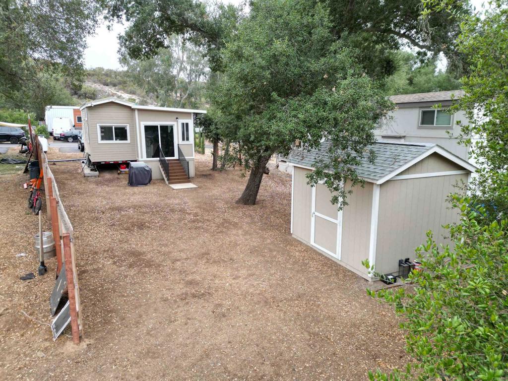 14625 Mussey Grade Road, Unit R67 Ramona, CA 92065 - Photo 21 of 31 a view of a house with backyard and trees
