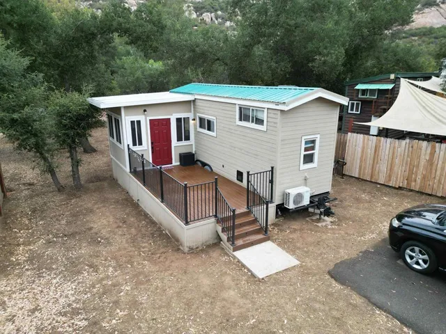a view of a house with a yard and deck