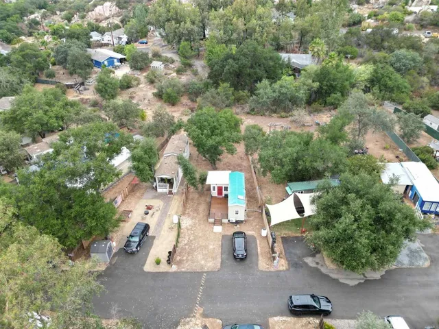 an aerial view of a houses with yard