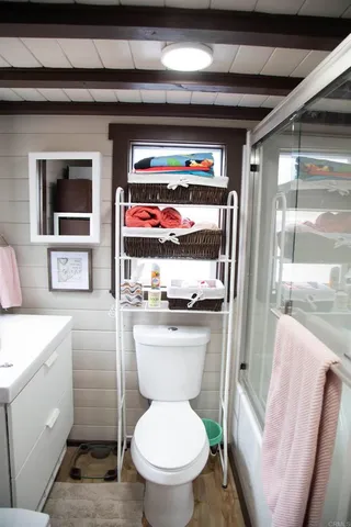 a bathroom with a toilet sink and mirror