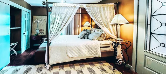 a bedroom with a bed and a window