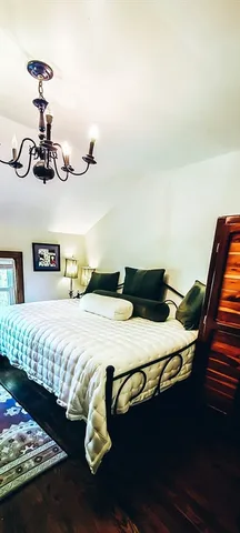 a bedroom with a bed and dresser