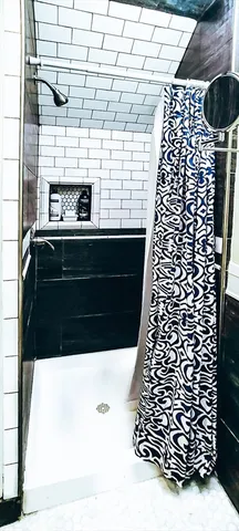 a bathroom with a black white checkered floor