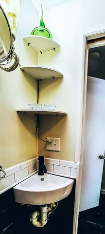 a room with a sink and cabinets