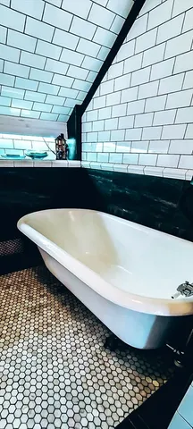 a bathroom with a bathtub and shower