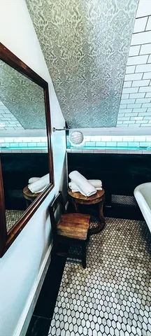 a bathroom with a sink toilet and window