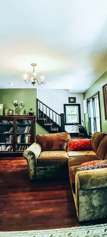 a bedroom with furniture and a rug