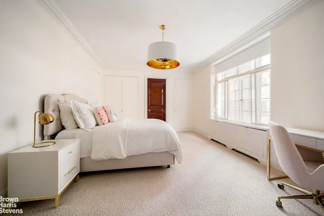 a bed room with a bed and a window