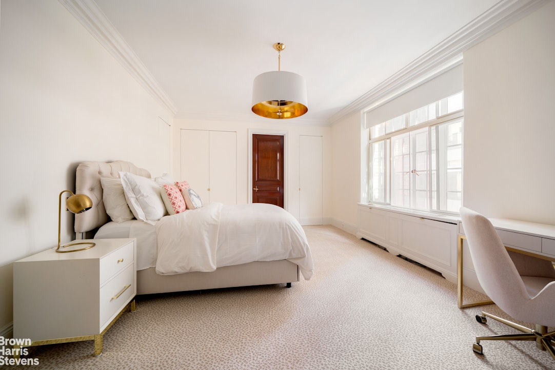116 East 68th Street, Unit 7/8D Manhattan, NY 10065 - Photo 12 of 14 a bed room with a bed and a window