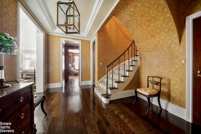 a view of entryway with wooden floor and windows