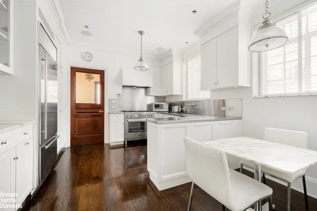a kitchen with granite countertop a sink a counter space stainless steel appliances and cabinets