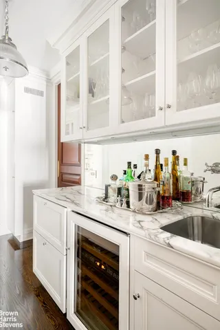 a kitchen with granite countertop a sink stainless steel appliances and cabinets