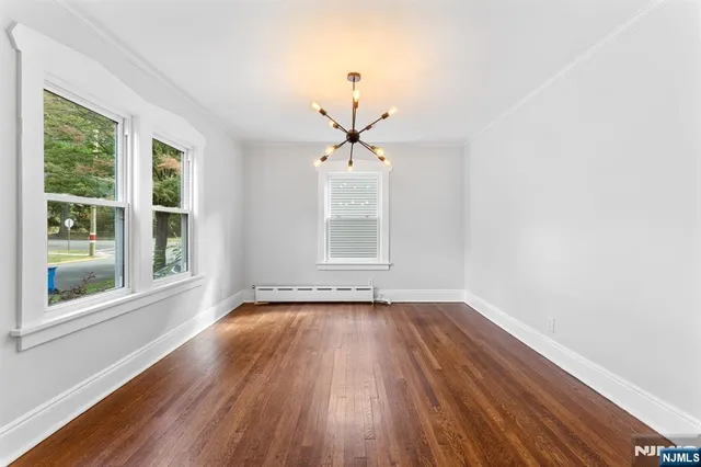 a view of wooden floor and windows in a room