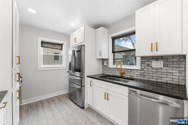 a kitchen with a sink stove and refrigerator