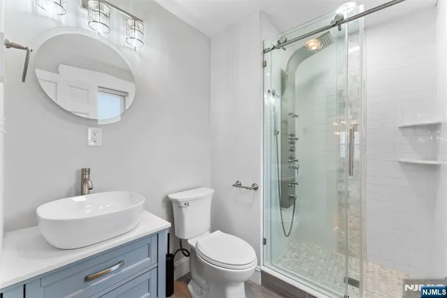 a bathroom with a toilet a sink and a mirror