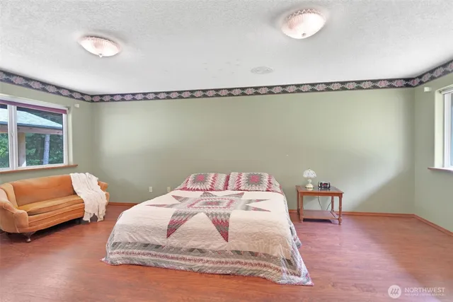 a bedroom with a large bed and a large window