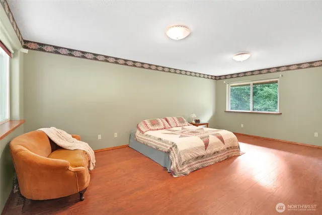 a dining room with furniture window and wooden floor