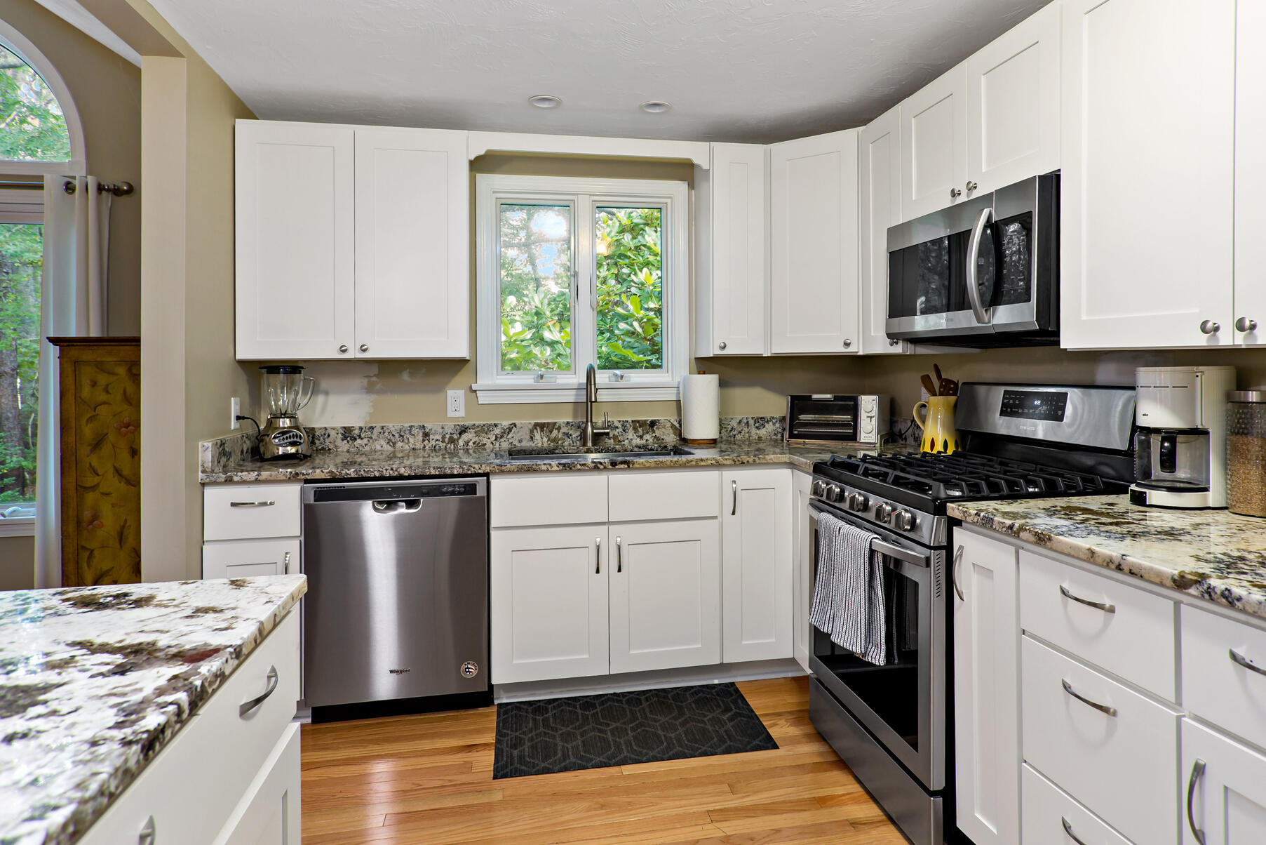 6 Friendship Court Mashpee, MA 02649 - Photo 5 of 39 a kitchen with stainless steel appliances granite countertop a stove a sink and a microwave