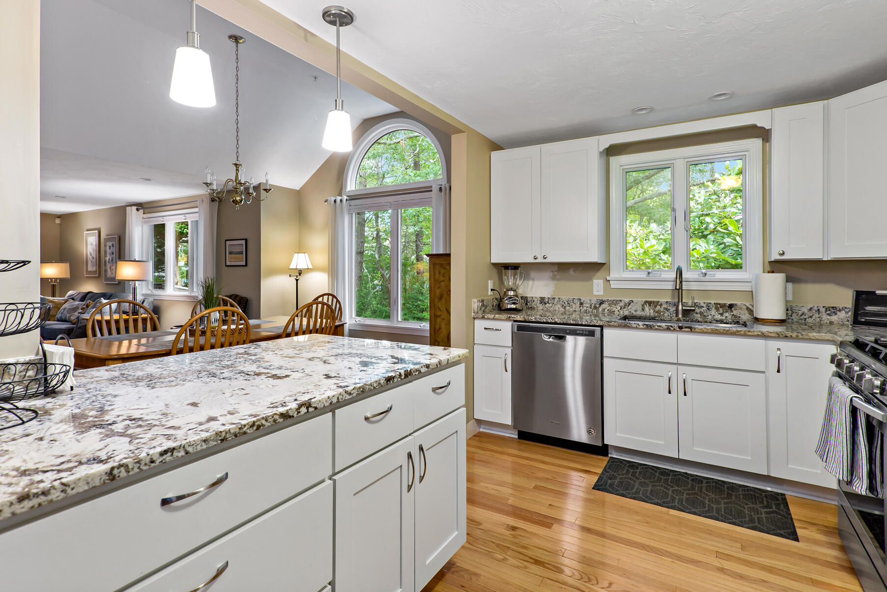 6 Friendship Court Mashpee, MA 02649 - Photo 6 of 39 a kitchen with granite countertop kitchen island a stove a sink a dining table and chairs