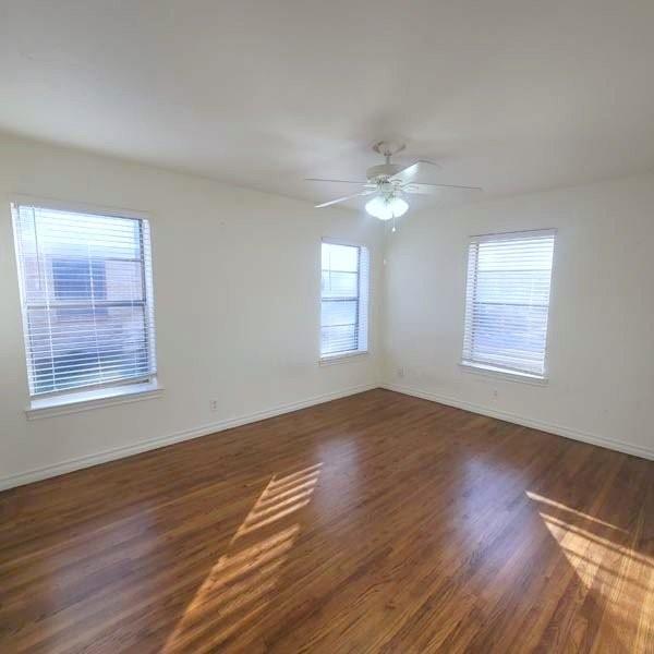 3459 Monte Carlo Street Dallas, TX 75224 - Photo 11 of 23 a view of an empty room with wooden floor and a window