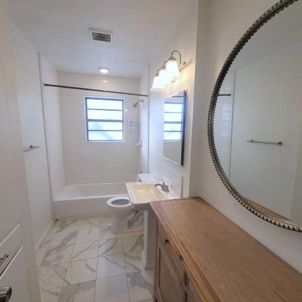 3459 Monte Carlo Street Dallas, TX 75224 - Photo 12 of 23 a spacious bathroom with a granite countertop sink a toilet and a mirror