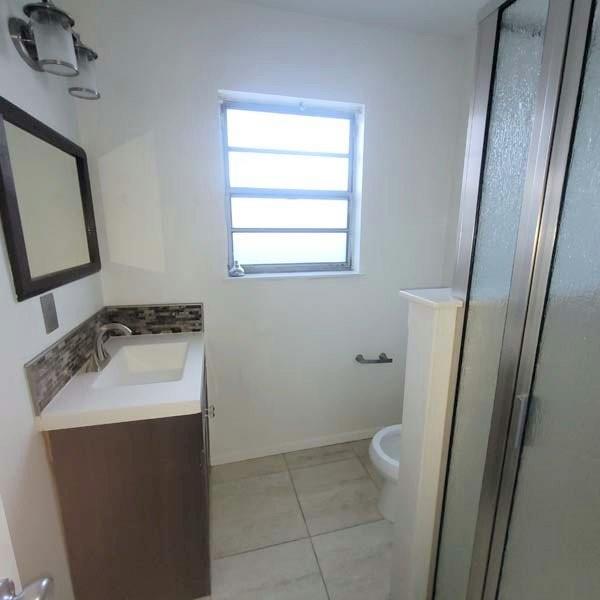 3459 Monte Carlo Street Dallas, TX 75224 - Photo 14 of 23 a bathroom with a sink toilet and shower