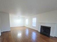 3459 Monte Carlo Street Dallas, TX 75224 - Photo 3 of 23 an empty room with wooden floor and a fireplace