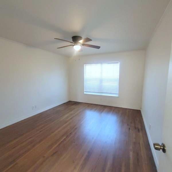 3459 Monte Carlo Street Dallas, TX 75224 - Photo 9 of 23 a view of an empty room with wooden floor and a window