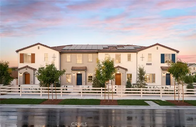 front view of house with a big yard and large trees