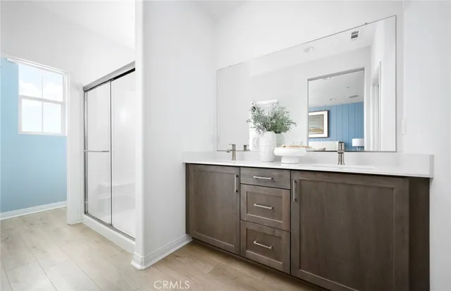 a bathroom with a double vanity sink mirror and