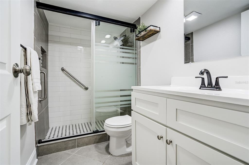 243 South McMullen Booth Road, Unit 29 Clearwater, FL 33759 - Photo 11 of 20 a bathroom with a sink a toilet and shower