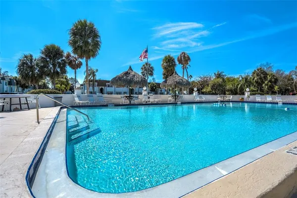 a view of a swimming pool with an outdoor space and seating area