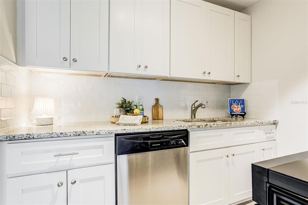 243 South McMullen Booth Road, Unit 29 Clearwater, FL 33759 - Photo 3 of 20 a kitchen with granite countertop white cabinets and a white appliances