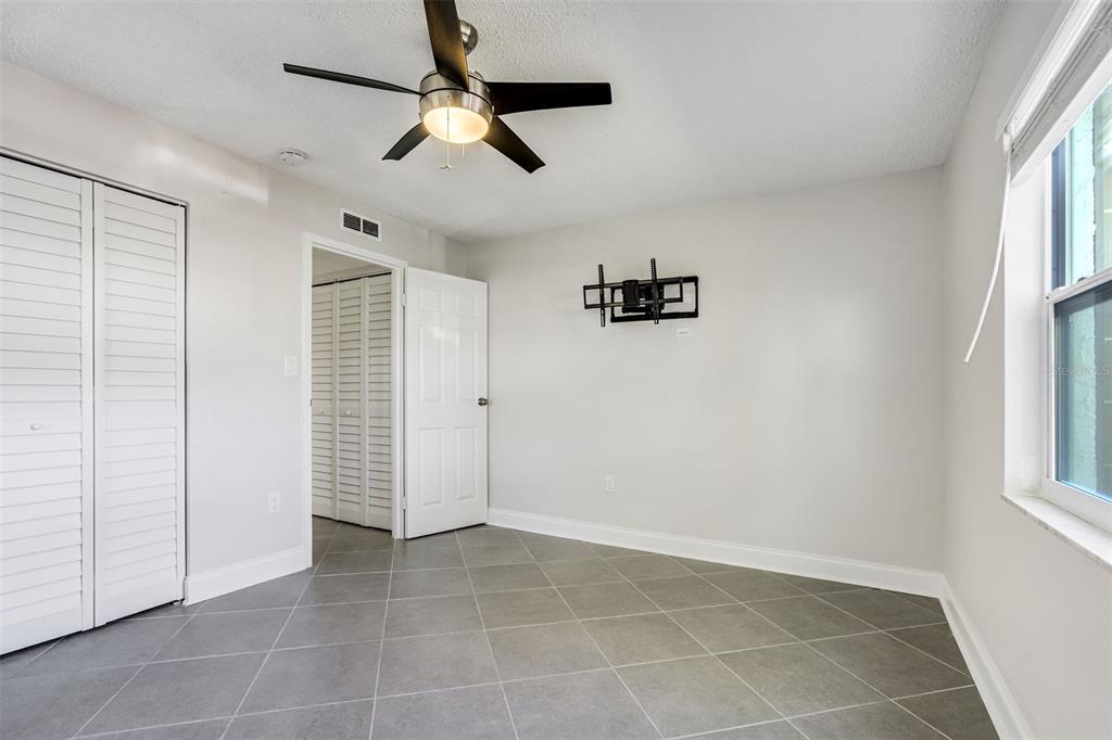 243 South McMullen Booth Road, Unit 29 Clearwater, FL 33759 - Photo 8 of 20 wooden floor in an empty room with a window