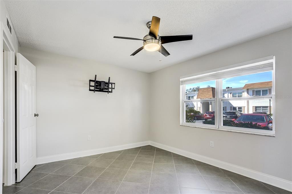 243 South McMullen Booth Road, Unit 29 Clearwater, FL 33759 - Photo 9 of 20 an empty room with a window and ceiling fan