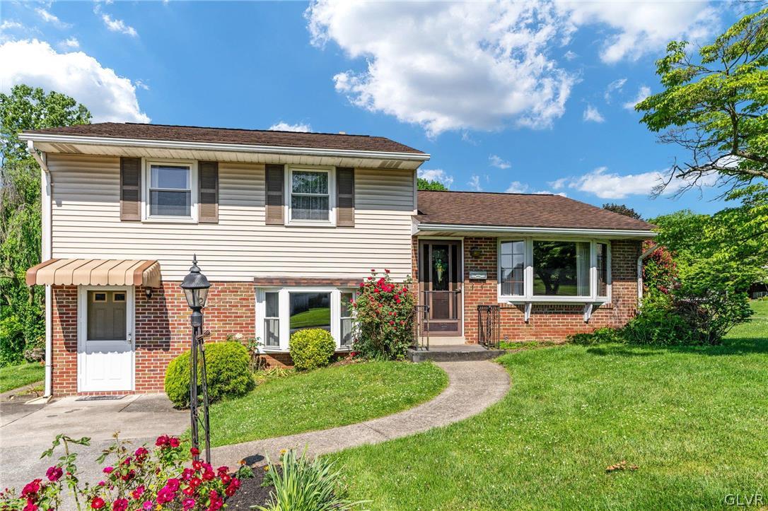 a front view of a house with a yard and porch