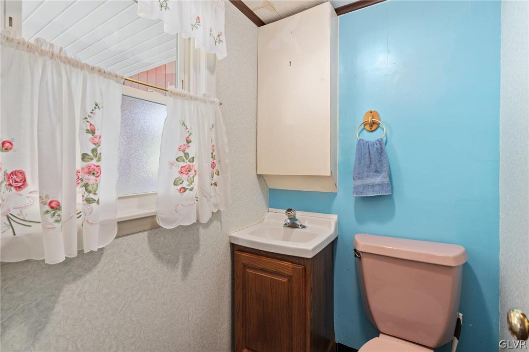 128 7th Street Whitehall, PA 18052 - Photo 19 of 29 a bathroom with a toilet sink and mirror