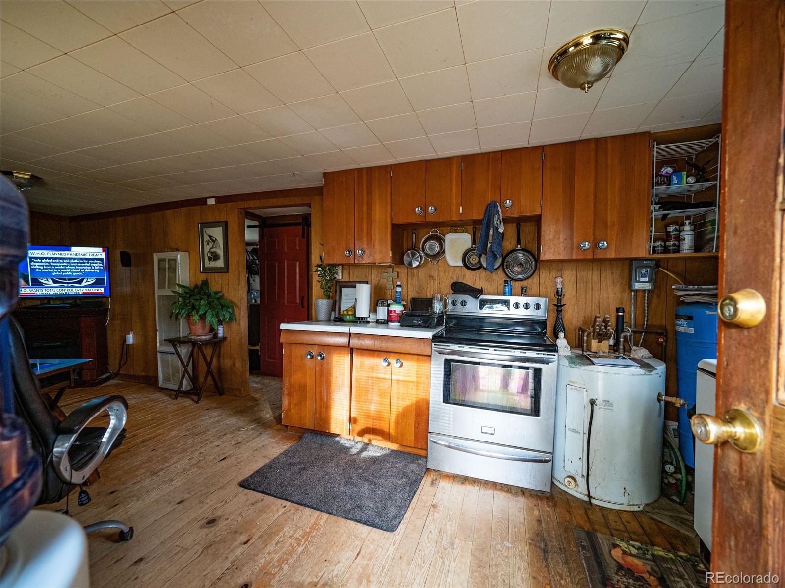 470 Mesa Drive Evergreen, CO 80439 - Photo 20 of 28 a kitchen with a stove and a wooden floor