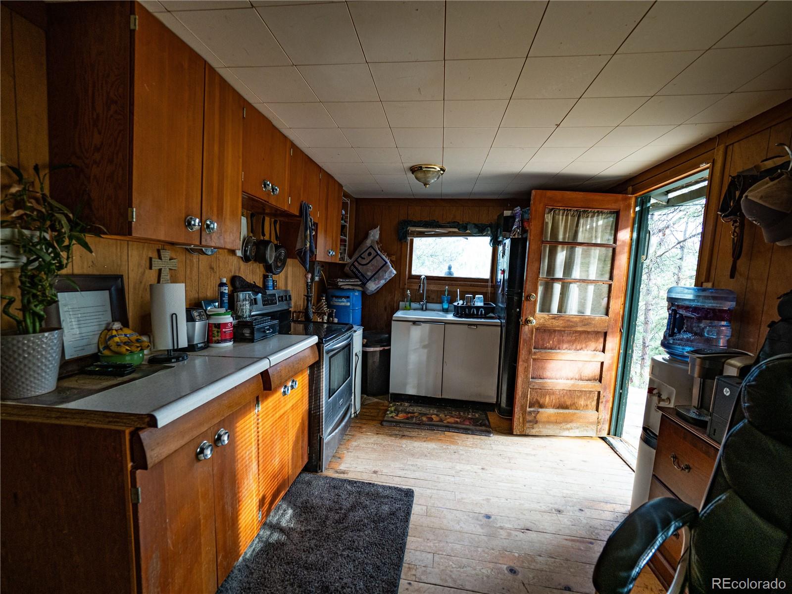 470 Mesa Drive Evergreen, CO 80439 - Photo 21 of 28 a kitchen with stainless steel appliances granite countertop a stove a sink dishwasher and a refrigerator