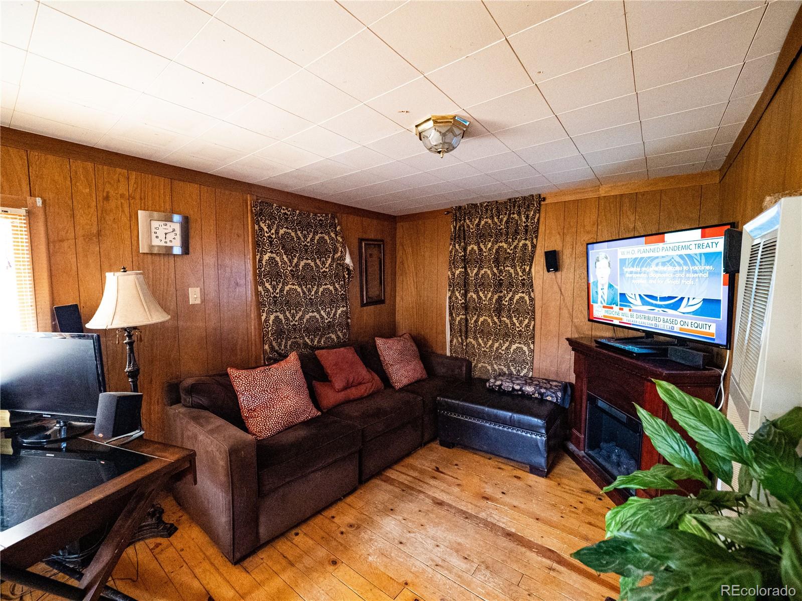 470 Mesa Drive Evergreen, CO 80439 - Photo 22 of 28 a living room with furniture and a flat screen tv