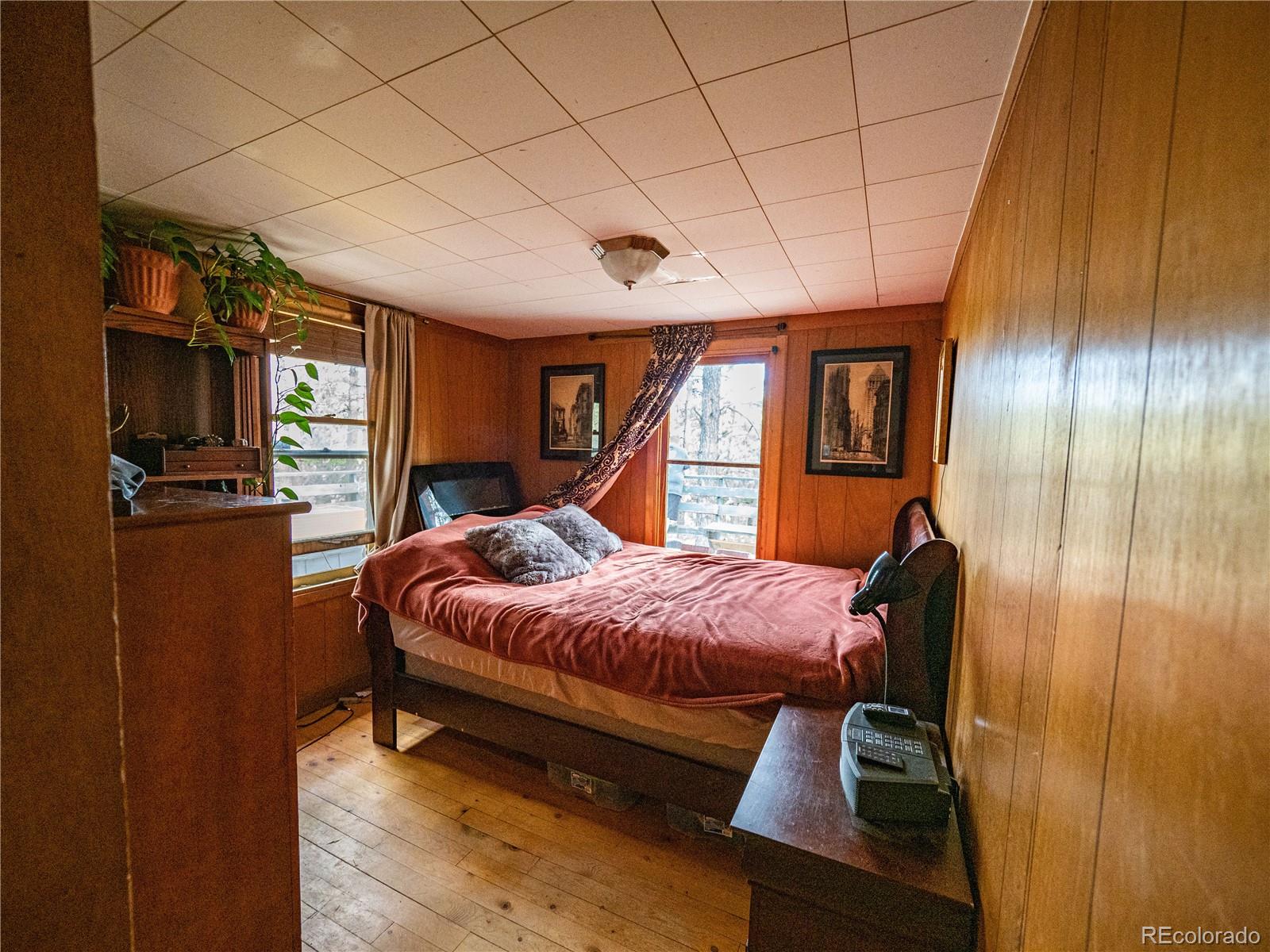 470 Mesa Drive Evergreen, CO 80439 - Photo 24 of 28 a bed room with a bed and a television